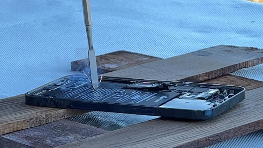 Puncturing a fully charged iPhone 12 battery with a sharp object Puncturing a fully charged iPhone 12 battery with a sharp object